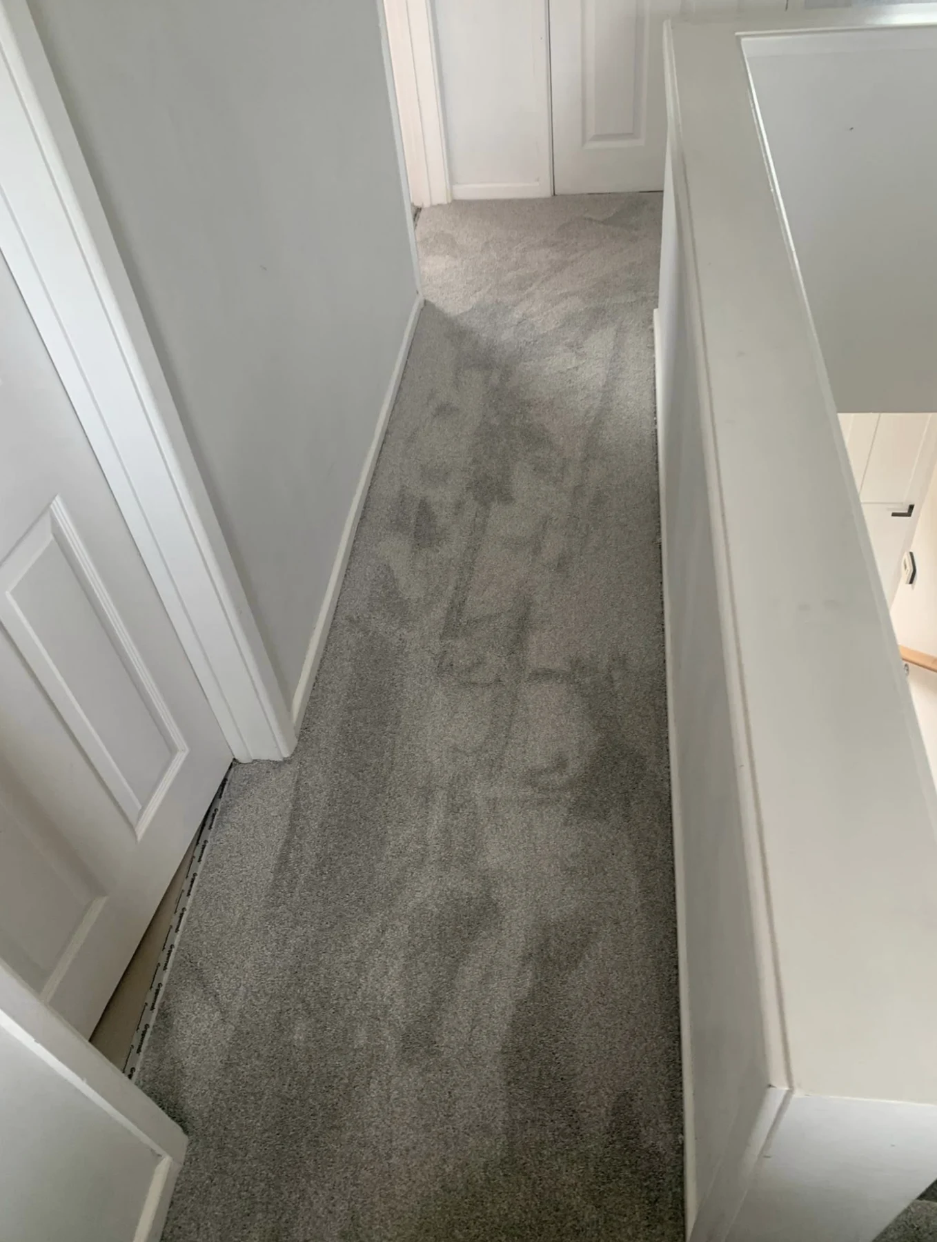 Grey carpet fitted in an upstairs hallway