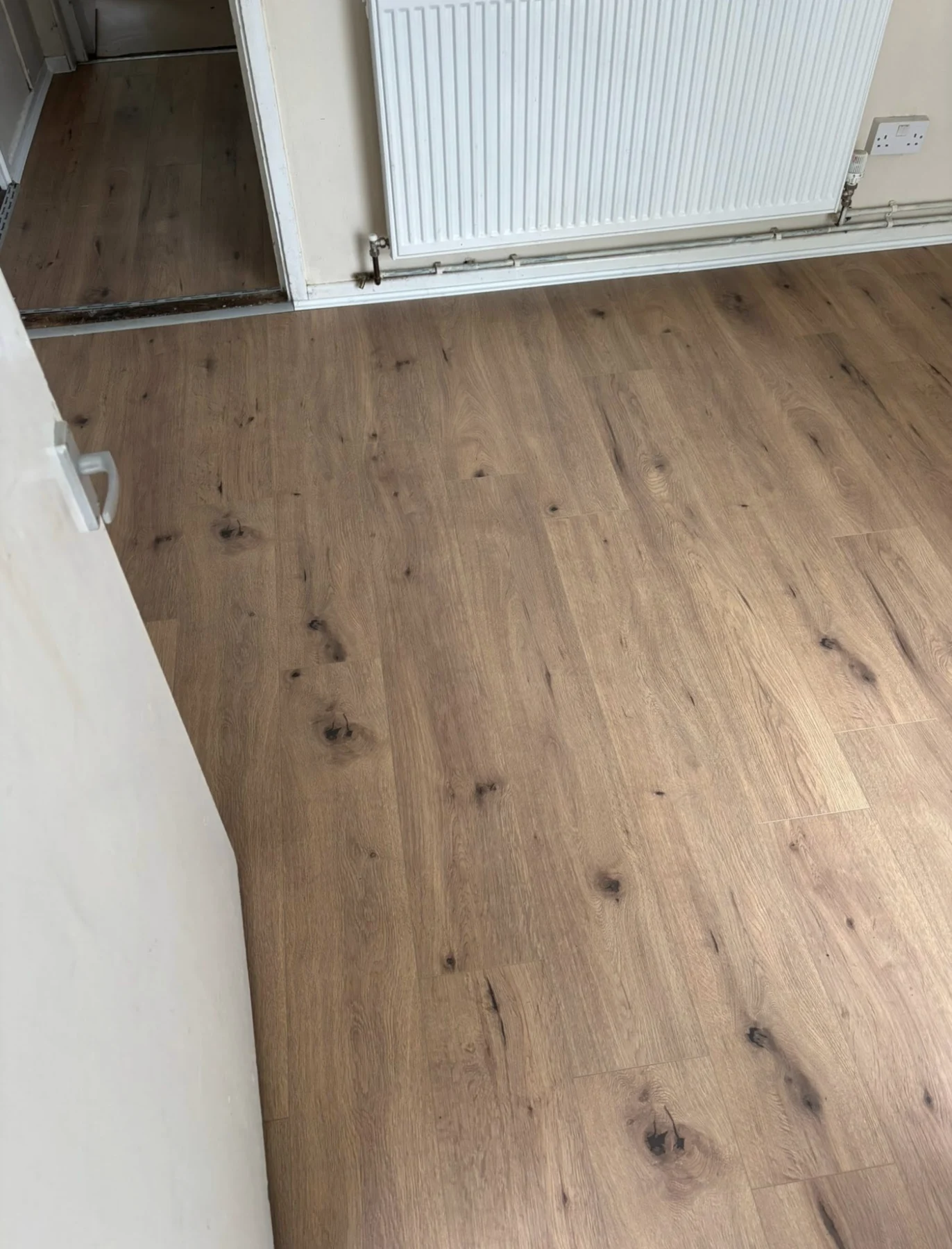 Oak-look plank flooring fitted in a hallway